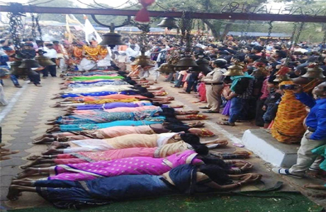 Women lie prone in Angarmoti Temple for child