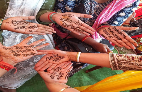 Women write demands in mehandi